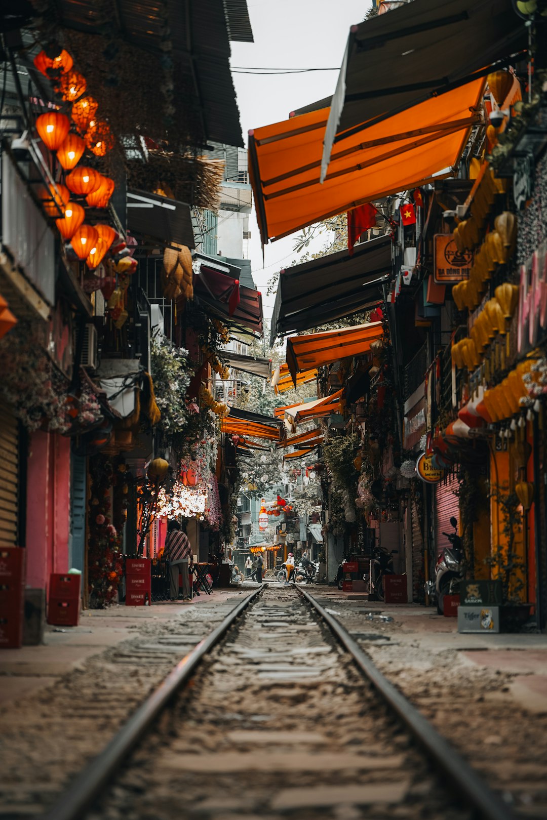 Narrow railway corridor in Hanoi Train Street lined with cafes and homes