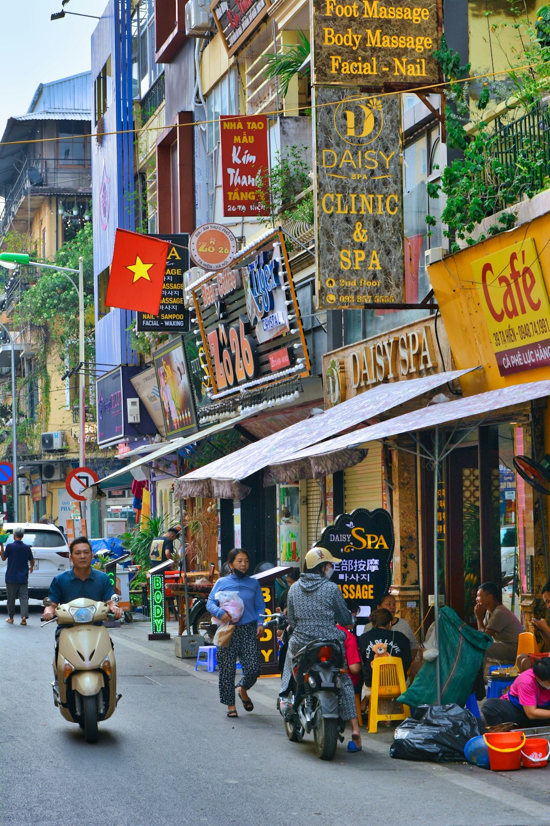 Hanoi Old Quarter street at night with lights and pedestrians